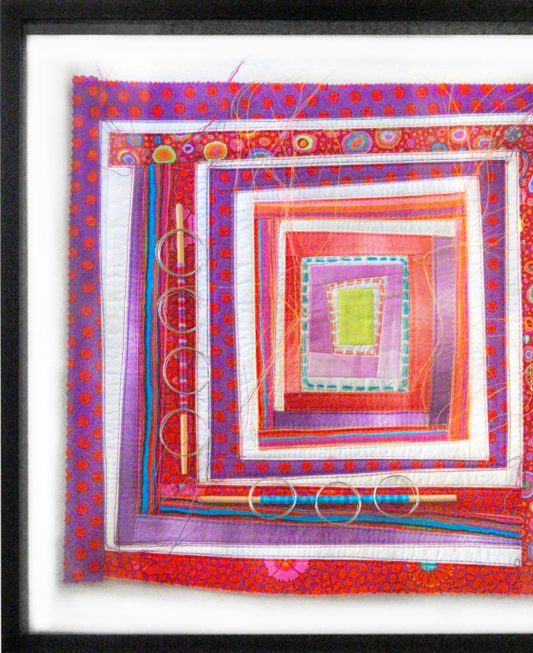 A framed abstract artwork featuring a spiral pattern of colorful rectangular layers, including red, purple, and white, with circular shapes and linear textures.